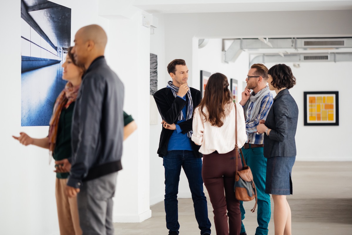 People talking at an art gallery.